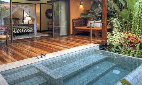 A large outdoor Jacuzzi with off of a suite’s private deck.